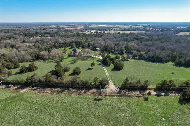 an aerial view of a residential houses with outdoor space