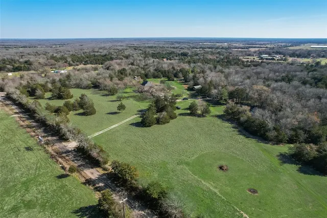 an aerial view of a house with a yard