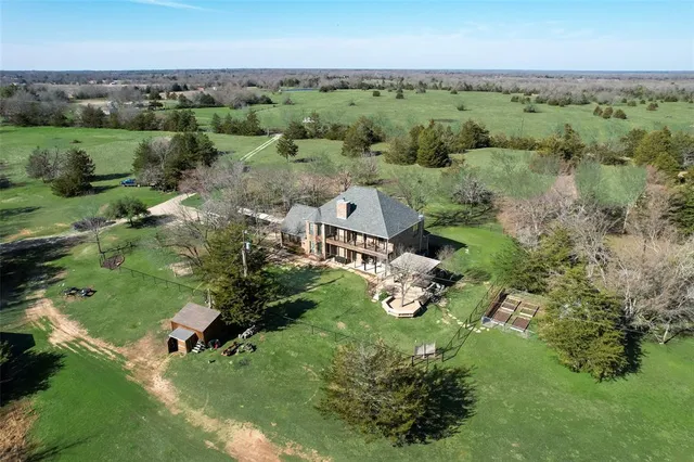 an aerial view of a house with a yard