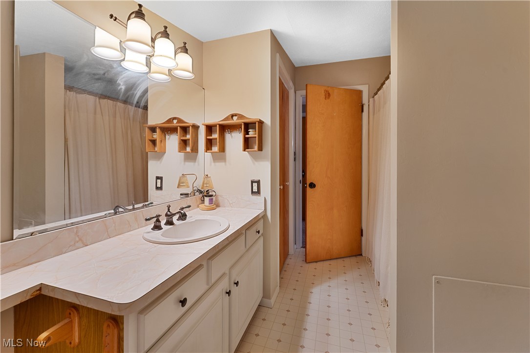6370 Fairview Road Youngstown, OH 44515 - Photo 30 of 38 Upstairs full bathroom featuring vanity, light flooring, and curtained shower