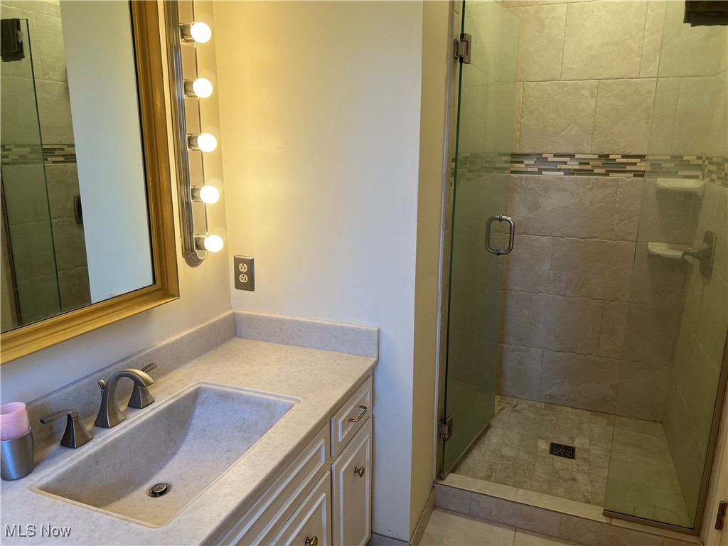3330 Stanley Road Akron, OH 44333 - Photo 15 of 22 Bathroom with vanity, tile patterned floors, and walk in shower