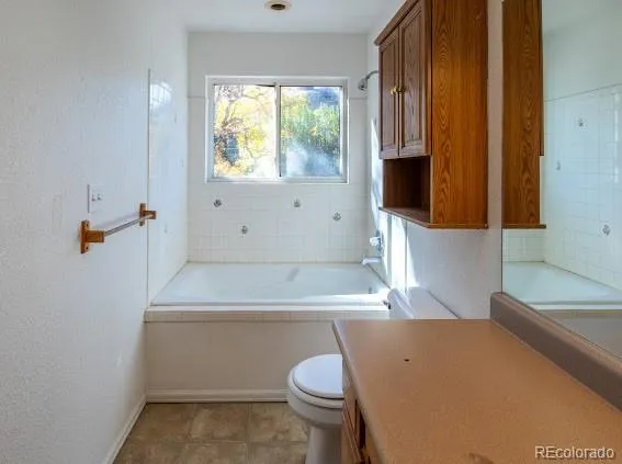 a bathroom with a sink toilet and window