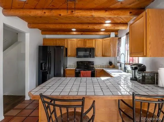 a kitchen with a table chairs and a refrigerator