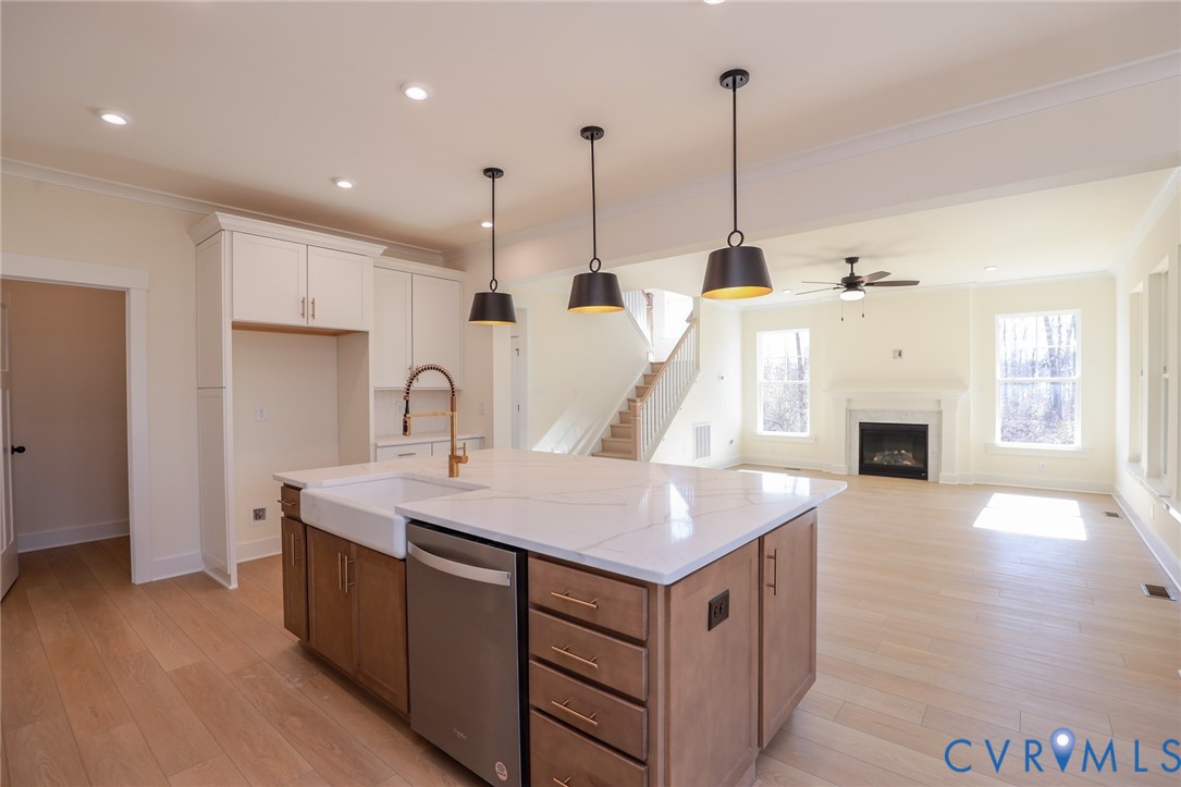 12320 Coalboro Road Chesterfield, VA 23838 - Photo 4 of 15 a kitchen with a sink a faucet a fireplace and wooden floor
