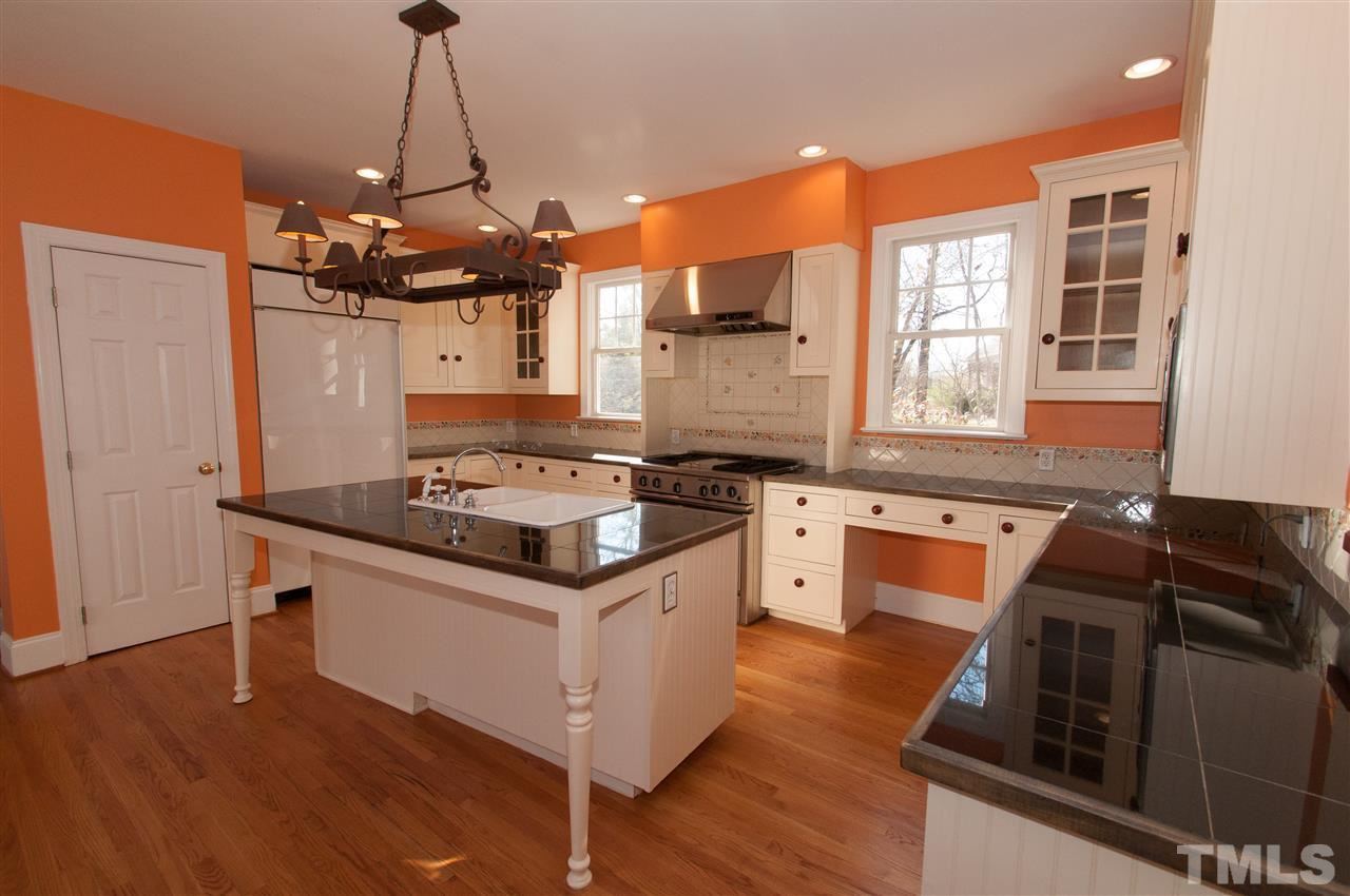 13423 Melvin Arnold Road Raleigh, NC 27613 - Photo 9 of 25 Large island/bar, granite counter top, fabulous stainless steel gas stove with grill, plenty of cabinets and a walk in pantry Kitchen