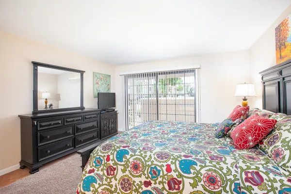 a bedroom with a bed and a dresser