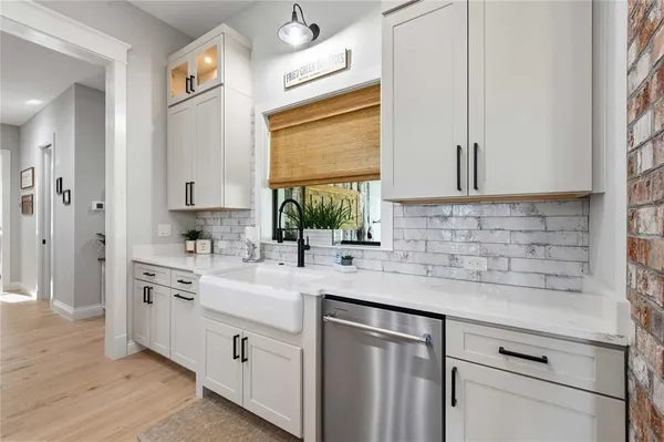 a bathroom with a granite countertop sink a toilet and a shower