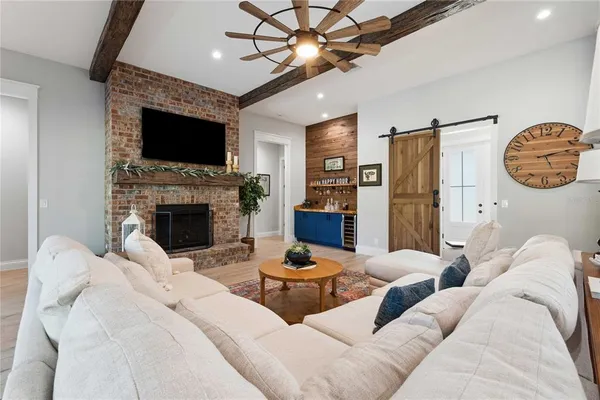 a living room with furniture a flat screen tv and a fireplace