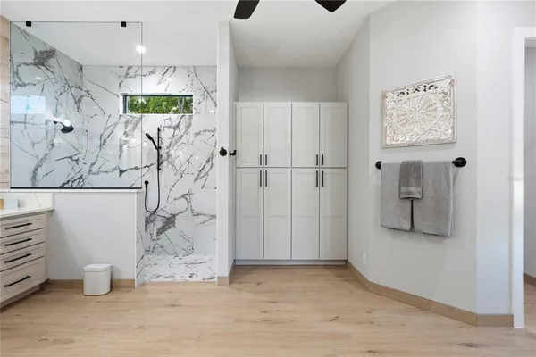 a house with a big yard and potted plants in front of it