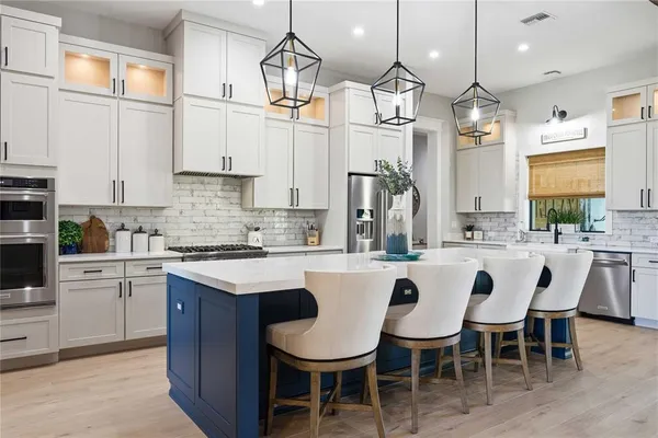 a bedroom with a bed and a lamp on dresser