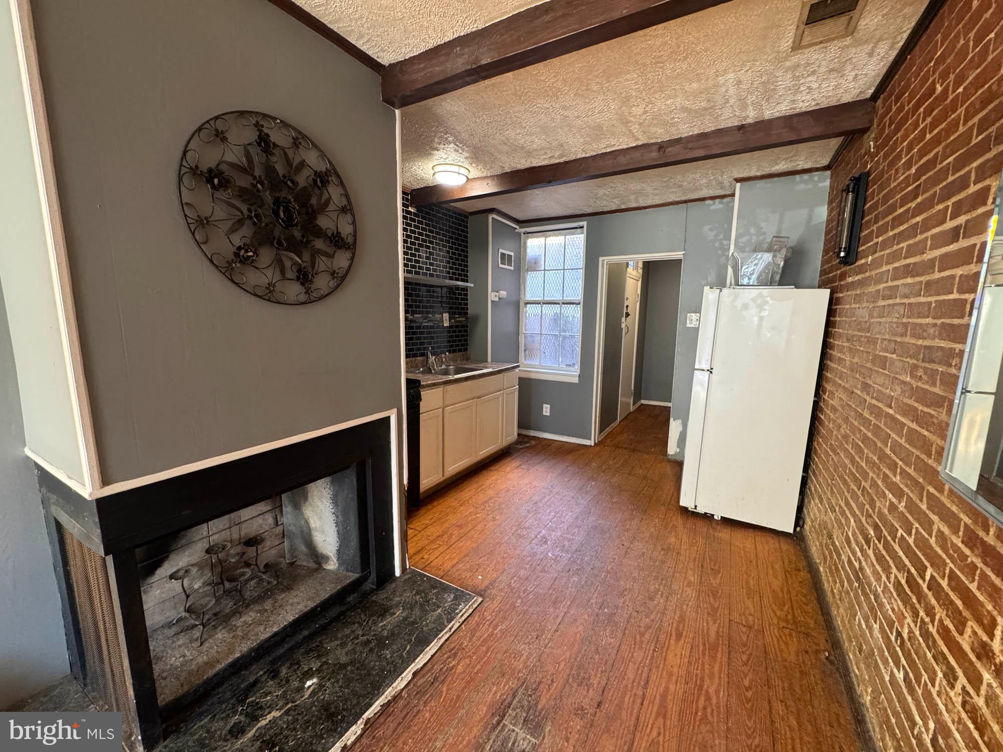 703 Tessier Street Baltimore, MD 21201 - Photo 4 of 11 a view of living room and wooden floor