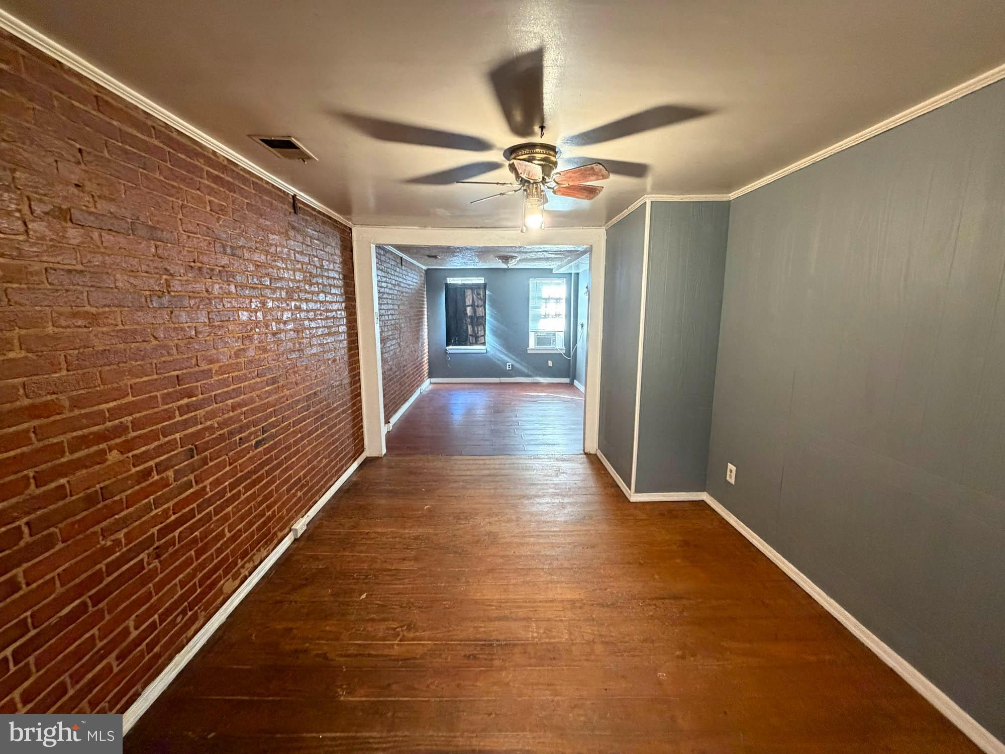 703 Tessier Street Baltimore, MD 21201 - Photo 9 of 12 a view of hallway with wooden floor