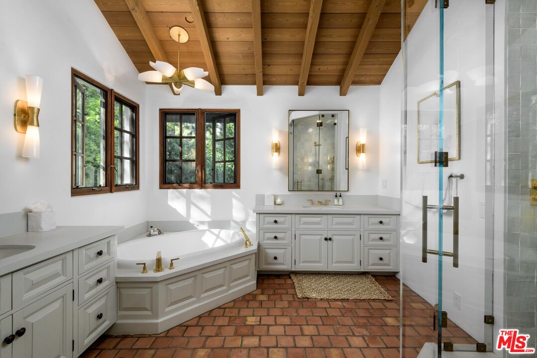 849 Ashley Road Montecito, CA 93108 - Photo 16 of 28 a spacious bathroom with a granite countertop tub sink and mirror