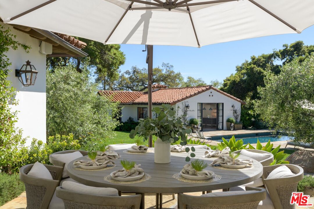 849 Ashley Road Montecito, CA 93108 - Photo 10 of 28 a view of a patio with couches table and chairs under an umbrella