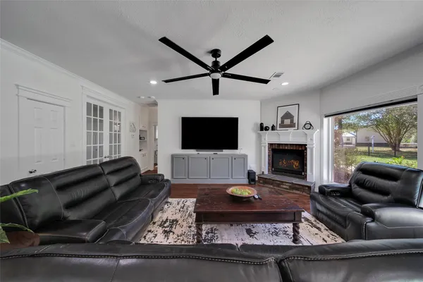 a living room with furniture a flat screen tv and a fireplace