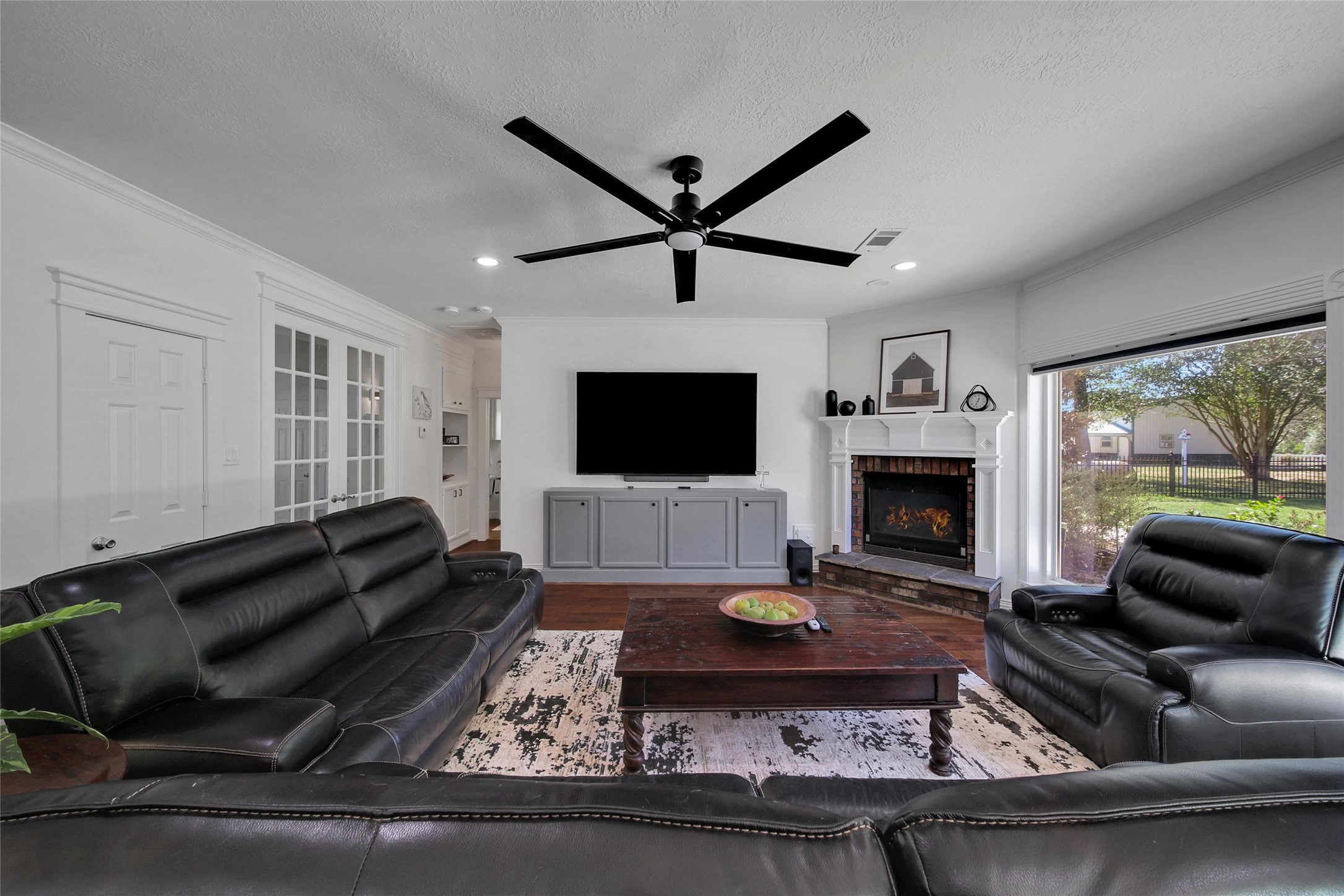 29919 Tudor Way Magnolia, TX 77355 - Photo 16 of 50 a living room with furniture a flat screen tv and a fireplace