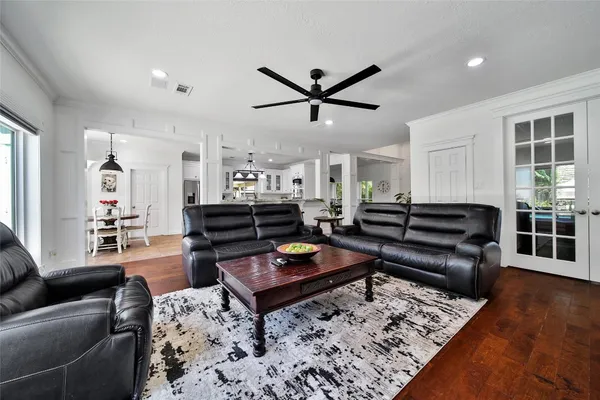 a living room with furniture and wooden floor