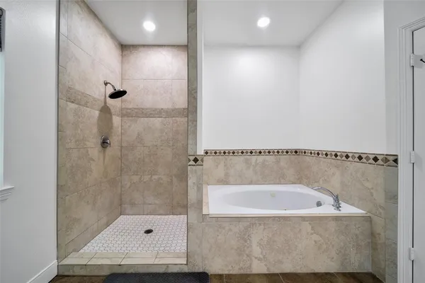 a bathroom with a tub and a shower