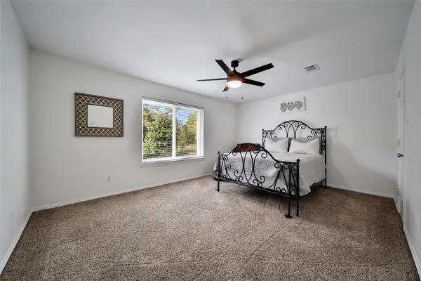 a living room with furniture a window and a ceiling fan