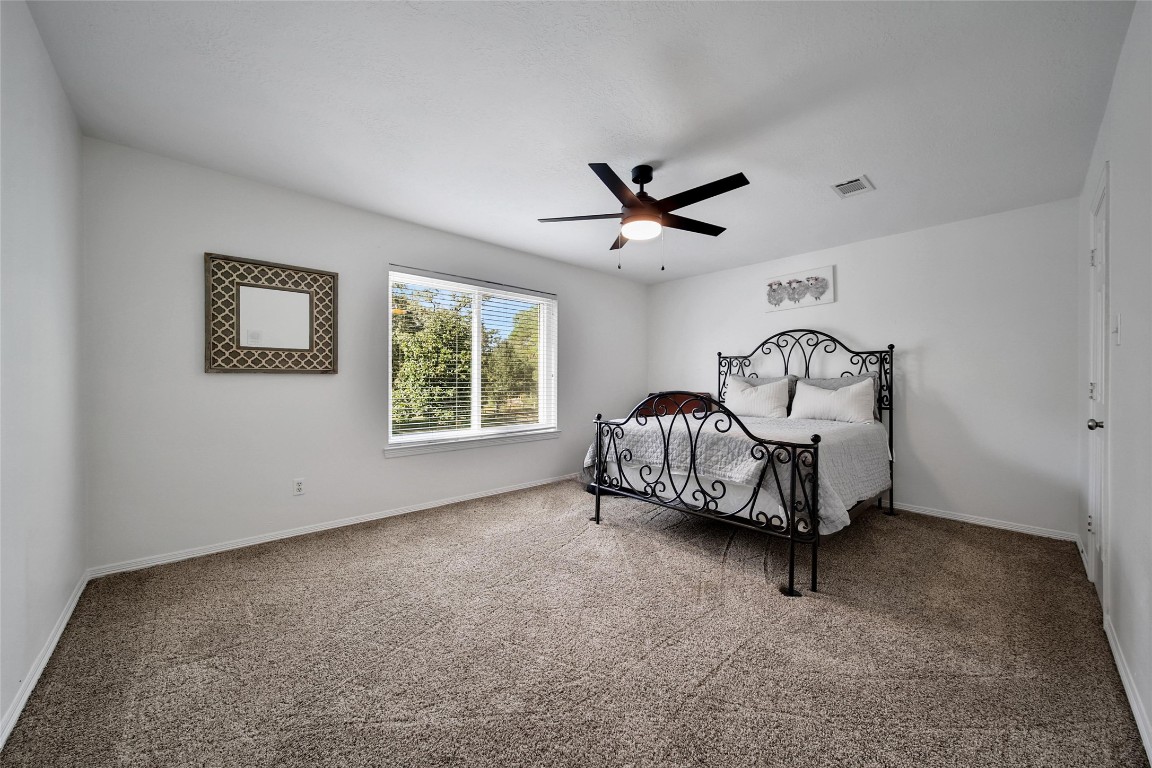 29919 Tudor Way Magnolia, TX 77355 - Photo 27 of 50 a living room with furniture a window and a ceiling fan