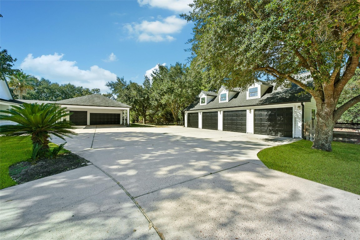 29919 Tudor Way Magnolia, TX 77355 - Photo 35 of 50 a front view of a house with a garden