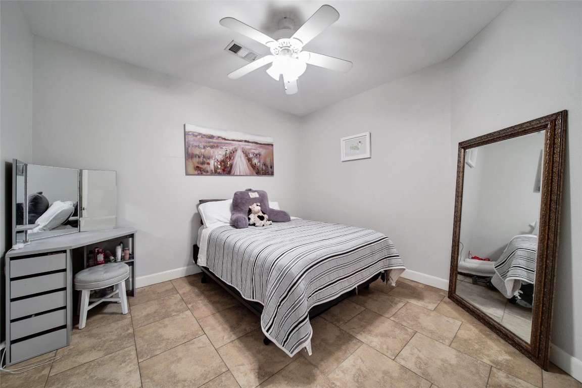 29919 Tudor Way Magnolia, TX 77355 - Photo 40 of 50 a bedroom with a bed and a chandelier