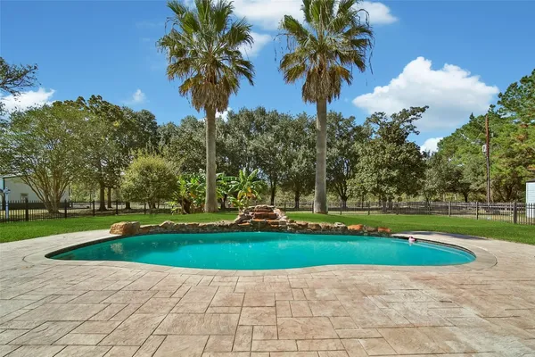 a view of a swimming pool with a yard