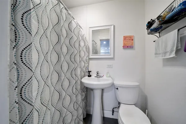a bathroom with a sink toilet and a mirror
