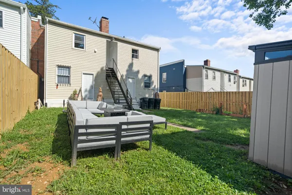 a front view of a house with backyard and patio