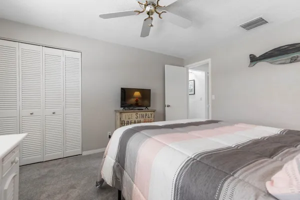 a bedroom with a bed and a tv