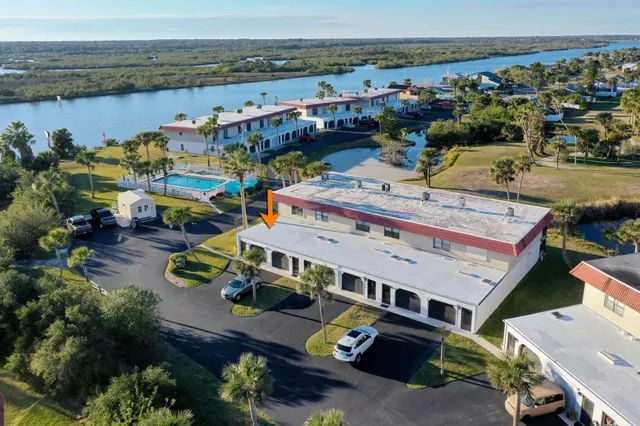 a view of a lake with a table and chairs