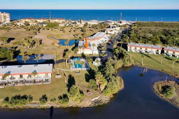 a aerial view of a house with a garden and lake view