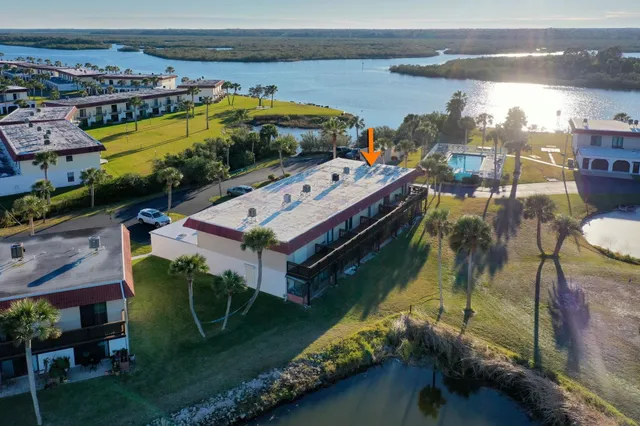 an aerial view of a building with outdoor space ocean view