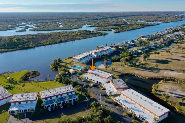 an aerial view of a swimming pool with a yard