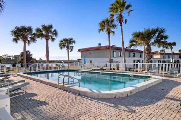a view of a swimming pool with a table and chair