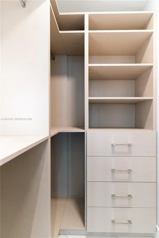 a view of a kitchen with a sink and cabinets
