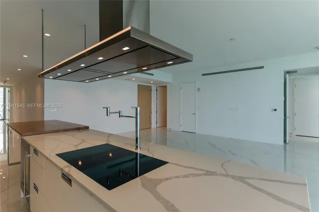 a kitchen with a sink a stove and a refrigerator