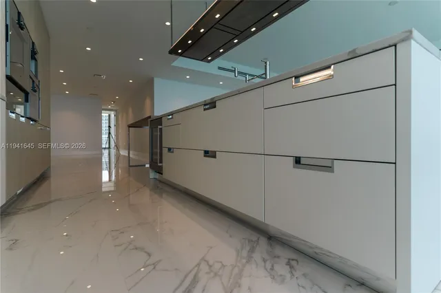 a kitchen with stainless steel appliances white cabinets and a microwave