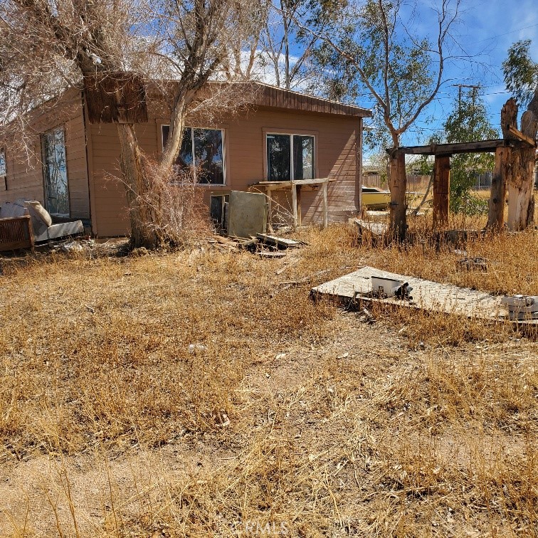 843 Sky Place Ridgecrest, CA 93555 - Photo 2 of 19 a backyard of a house with yard and seating area