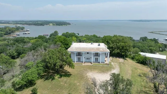 an aerial view of a house with lake view