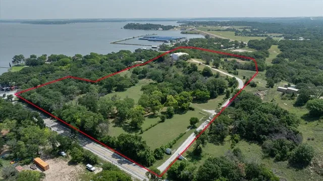 an aerial view of lake and residential houses with outdoor space