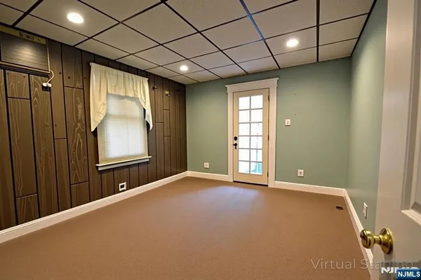 a storage room with wooden floor and windows