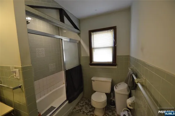 a bedroom with two beds and a flat screen tv