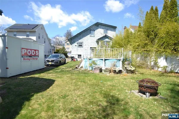 a white bench sitting in backyard of house