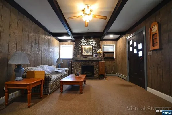 a living room with furniture a chandelier and a fireplace