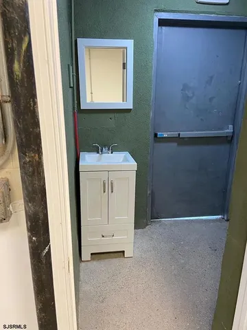a bathroom with a sink a mirror and a window