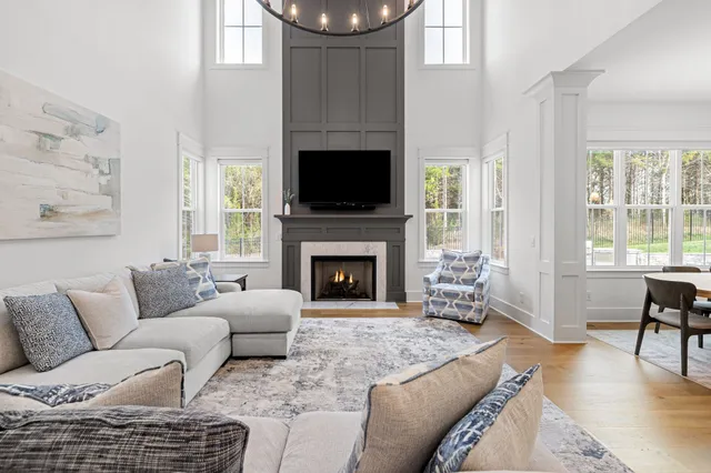 a kitchen with stainless steel appliances kitchen island granite countertop a table chairs sink and cabinets
