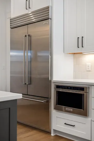 a spacious bedroom with a large bed and a chandelier