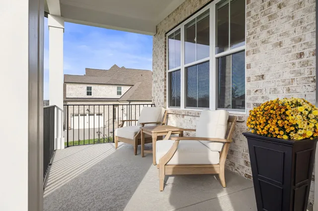 a dining room with furniture a chandelier and wooden floor