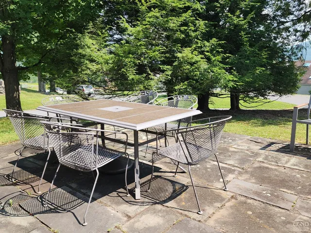 a terrace with outdoor seating and trees